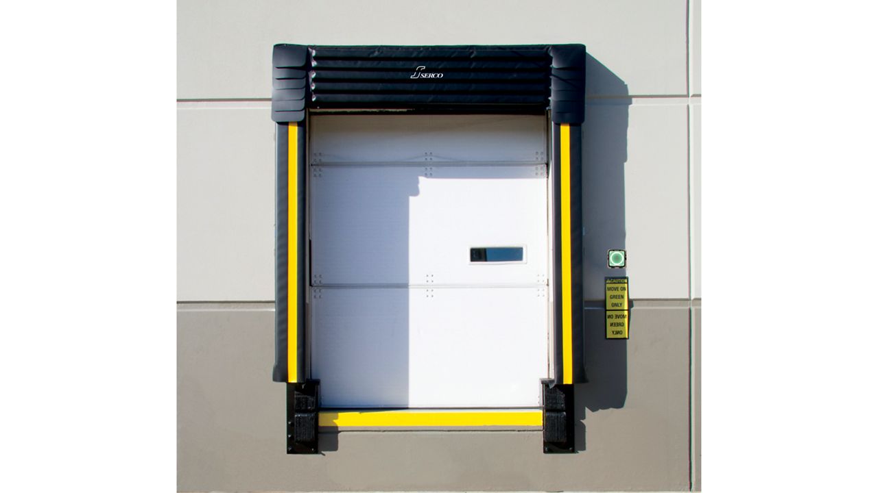 A white door with a black dock seal.