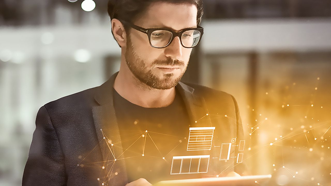 Man looking to a tablet getting insights of automatic and industrial doors