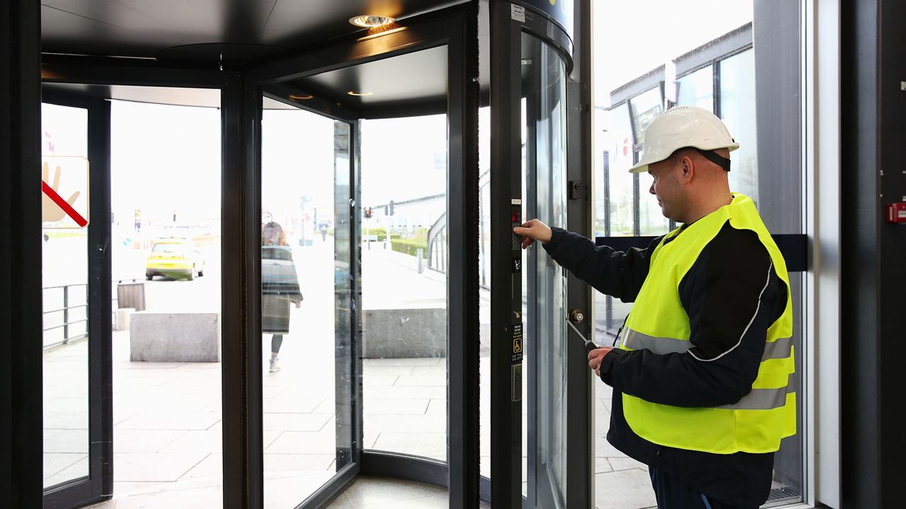ASSA ABLOY technician checking a revolving door