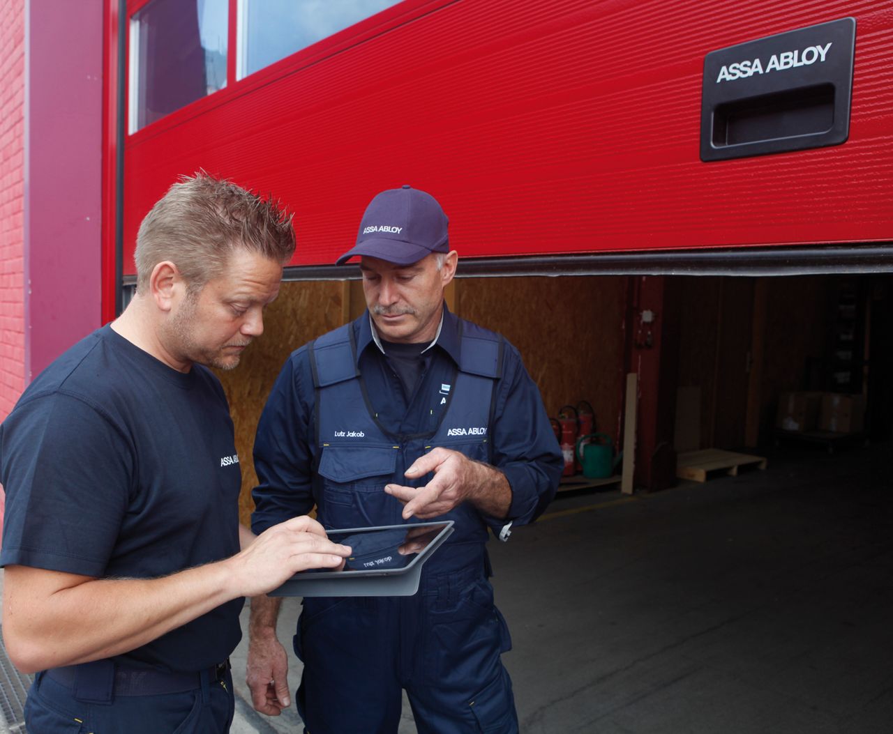 Service technicians in front of industrial door