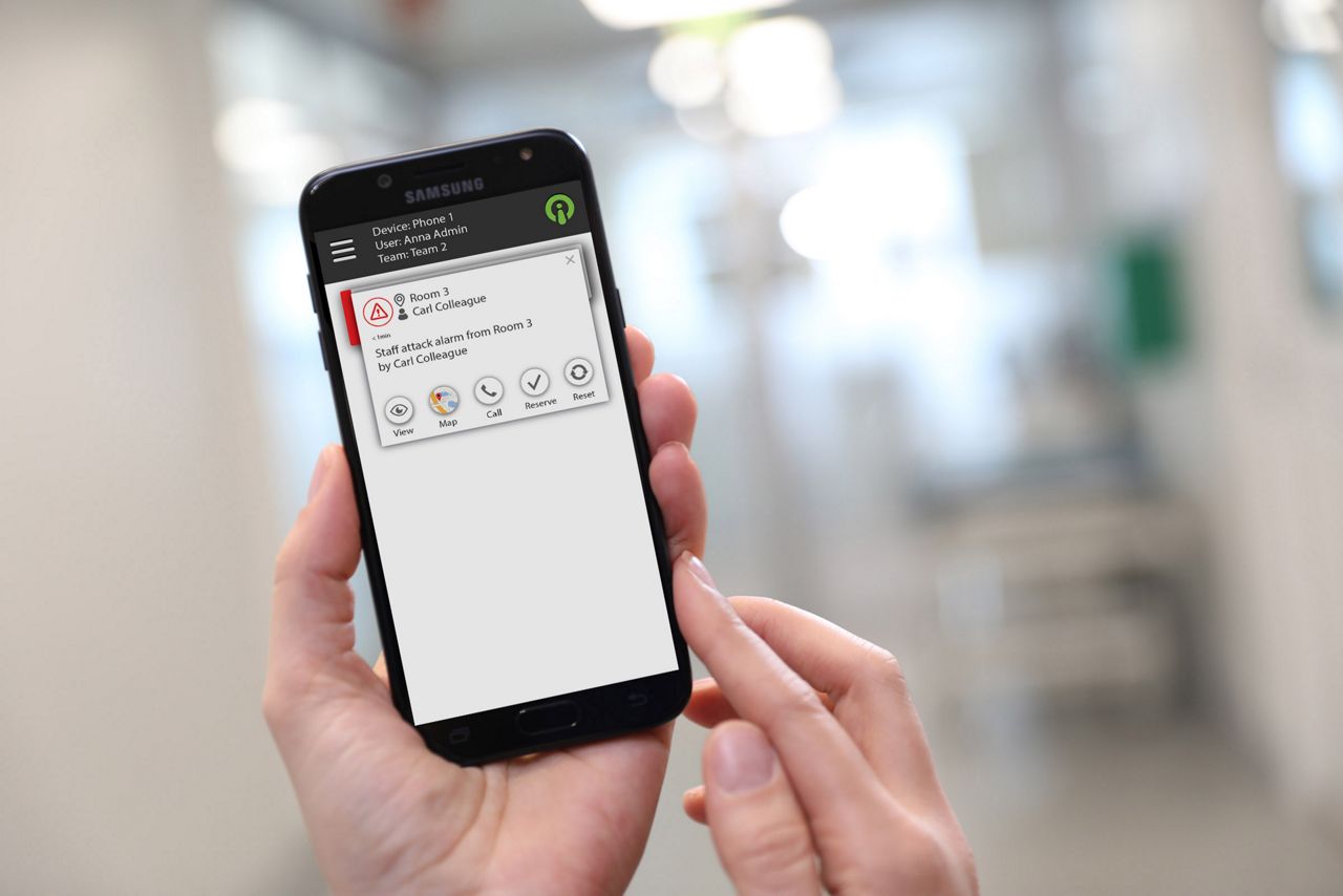 9Solutions Smooth Lite app open on a phone a nurse is holding