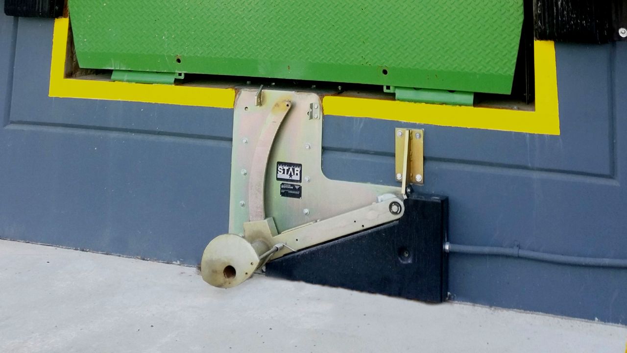 The Star4 vehicle restraint in use under a door outside of a warehouse