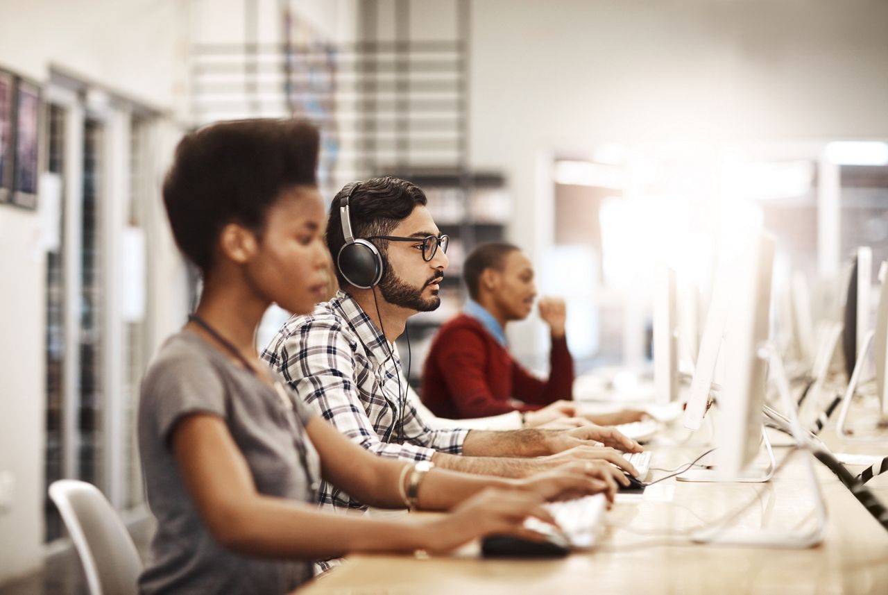 Students working at computer stations in a library