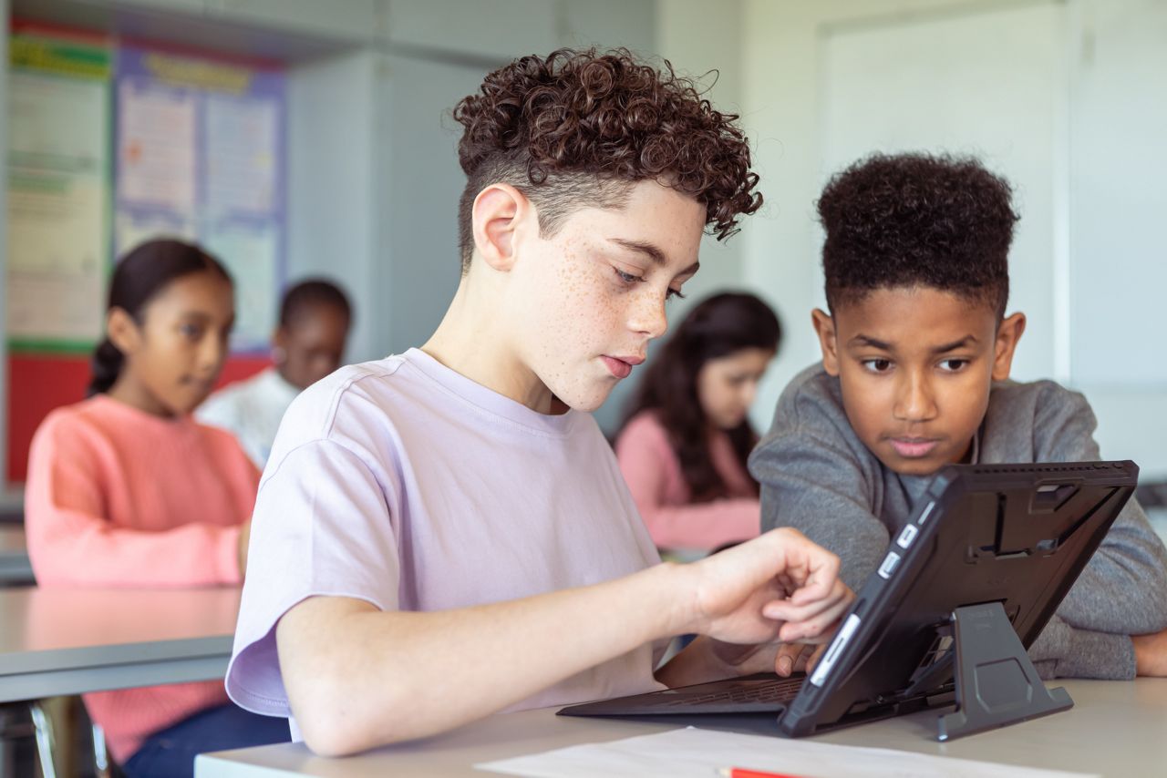 Two boys using a tablet in the classroom
