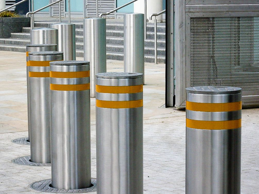 Titan automatic retractable bollard stainless steel with yellow stripes