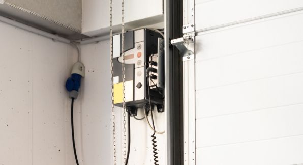 Industrietorsteuerung an der Wand neben einem Sektionaltor befestigt