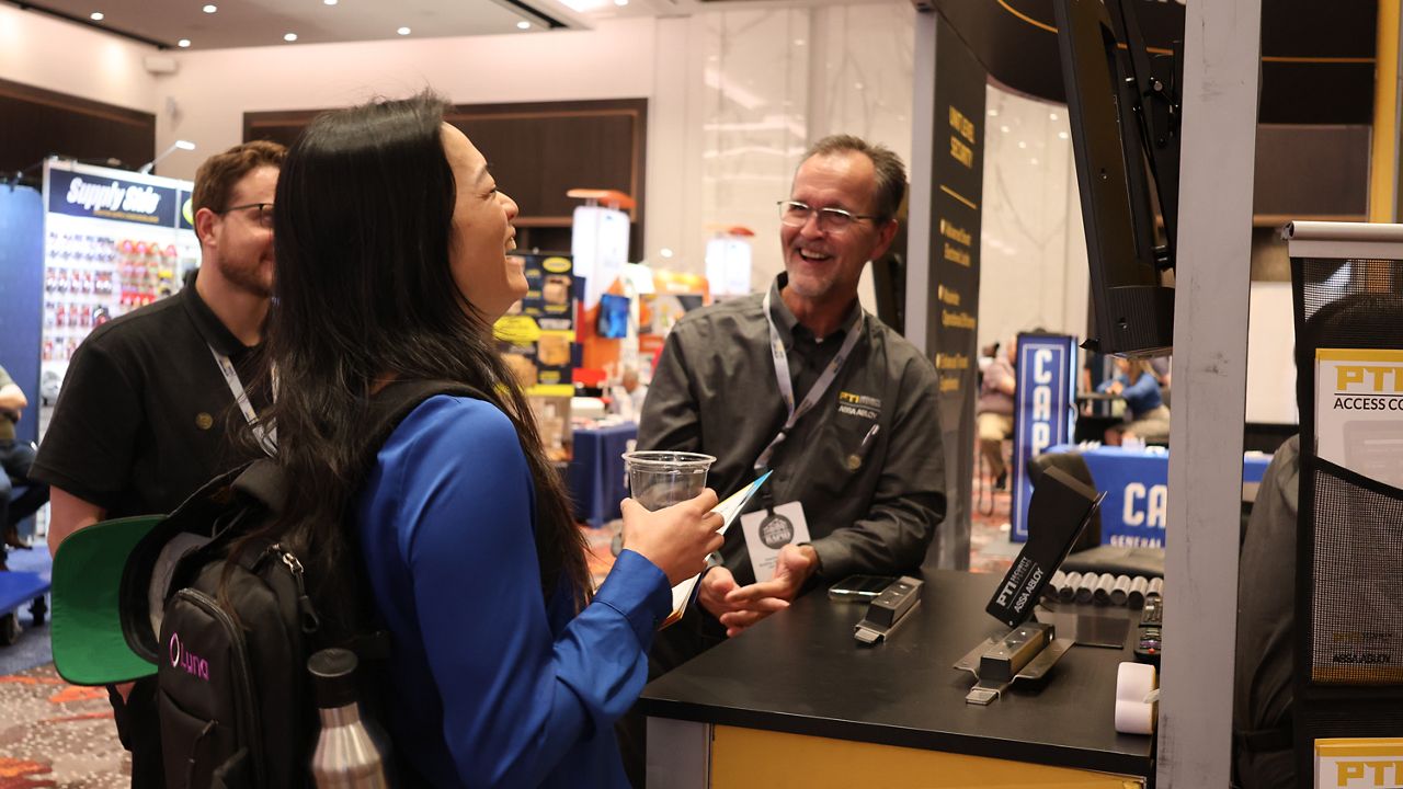 PTI team member at trade show booth.