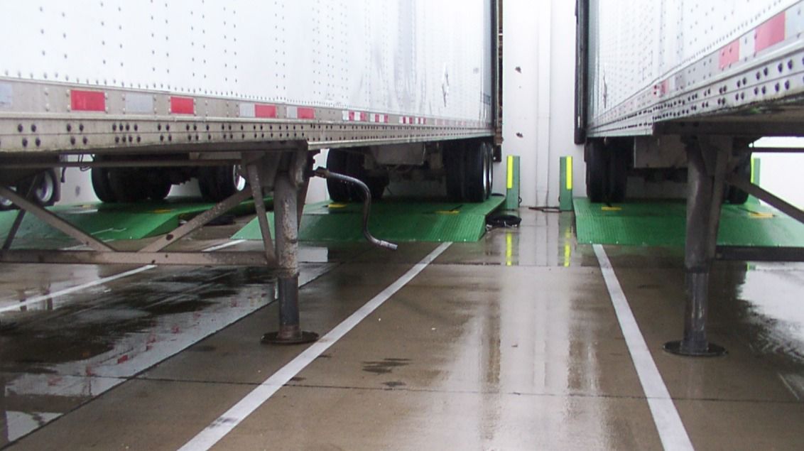 Two trucks outside using the ATL truck leveler