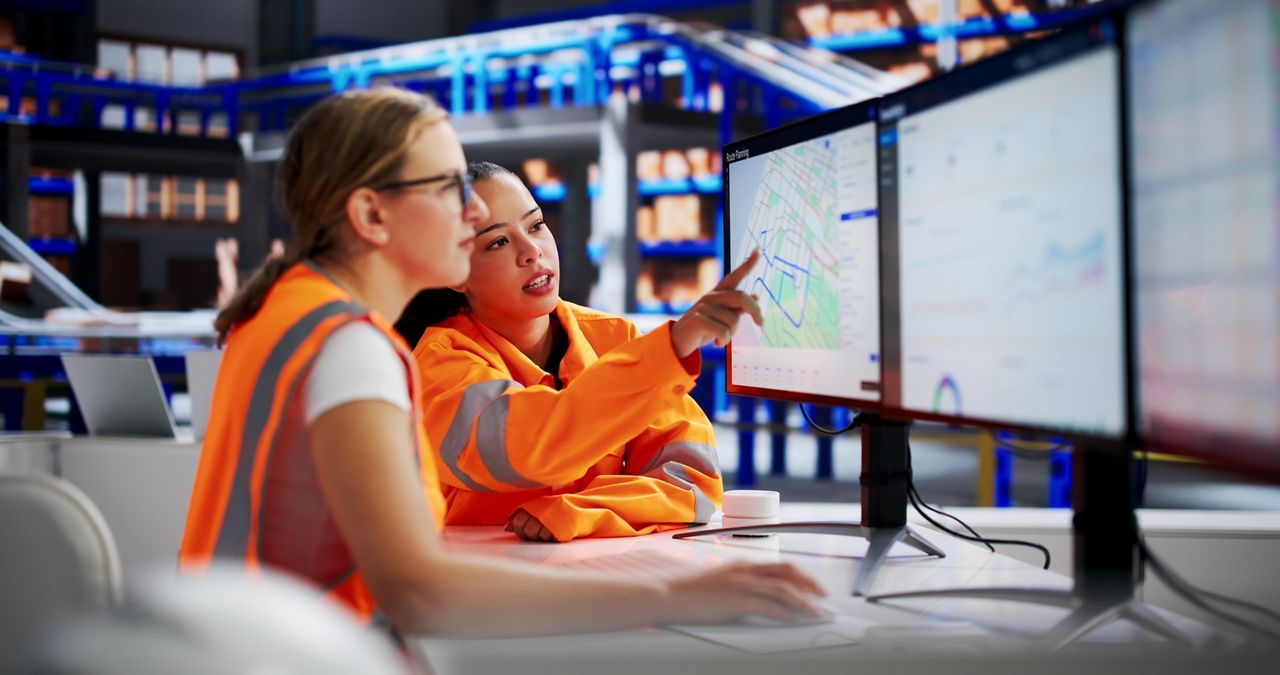 Two fleet workers at computer workstation
