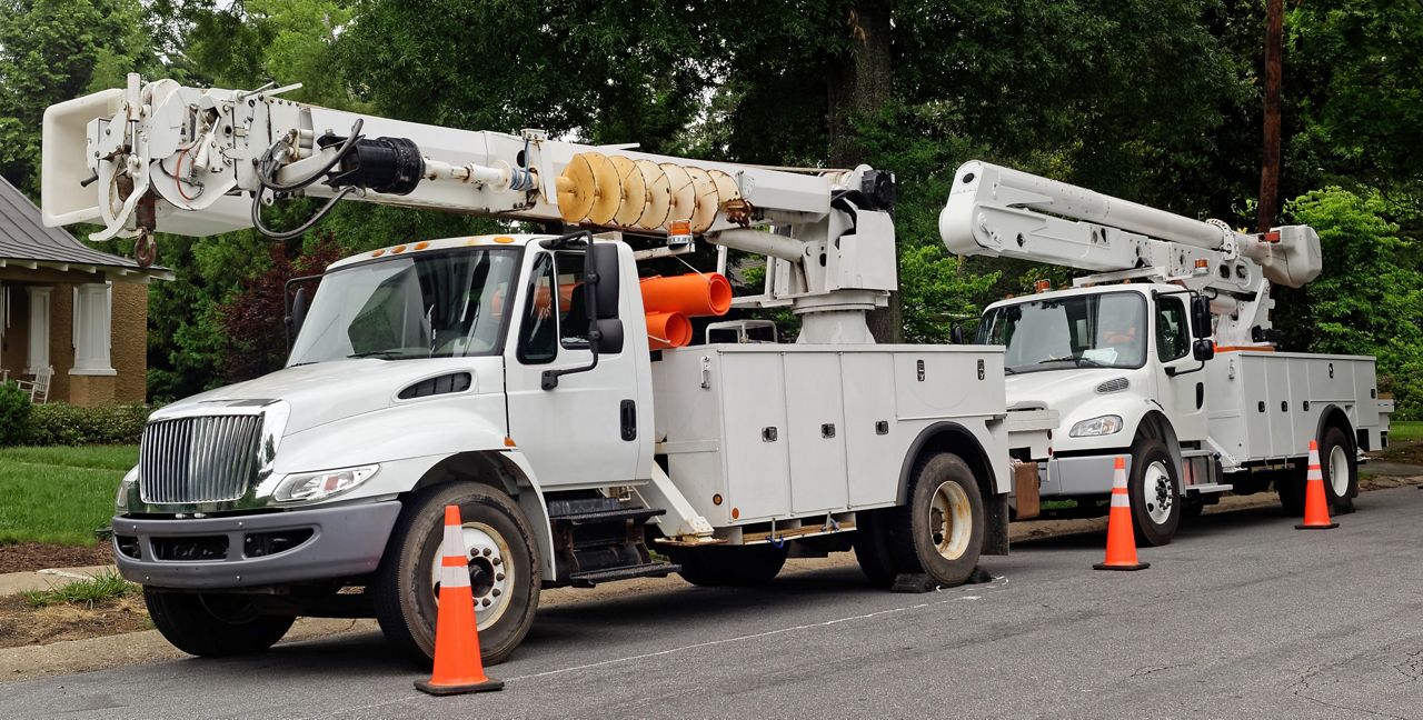 Utility vehicles parked on a suburban street