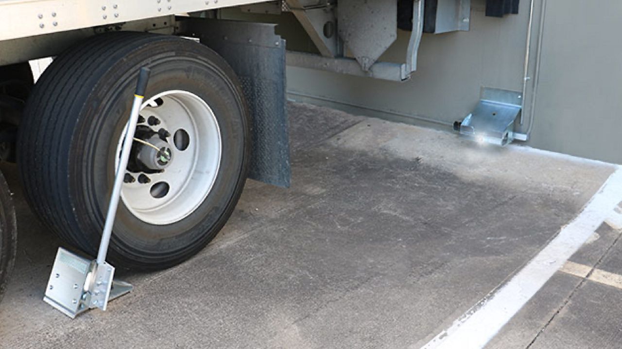The VersaChock system in action holding a trailer wheel in place. 