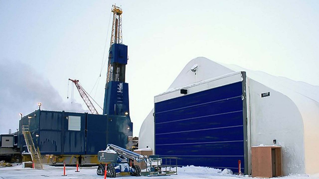 Blue rubber doors on a hangar with snow outside.