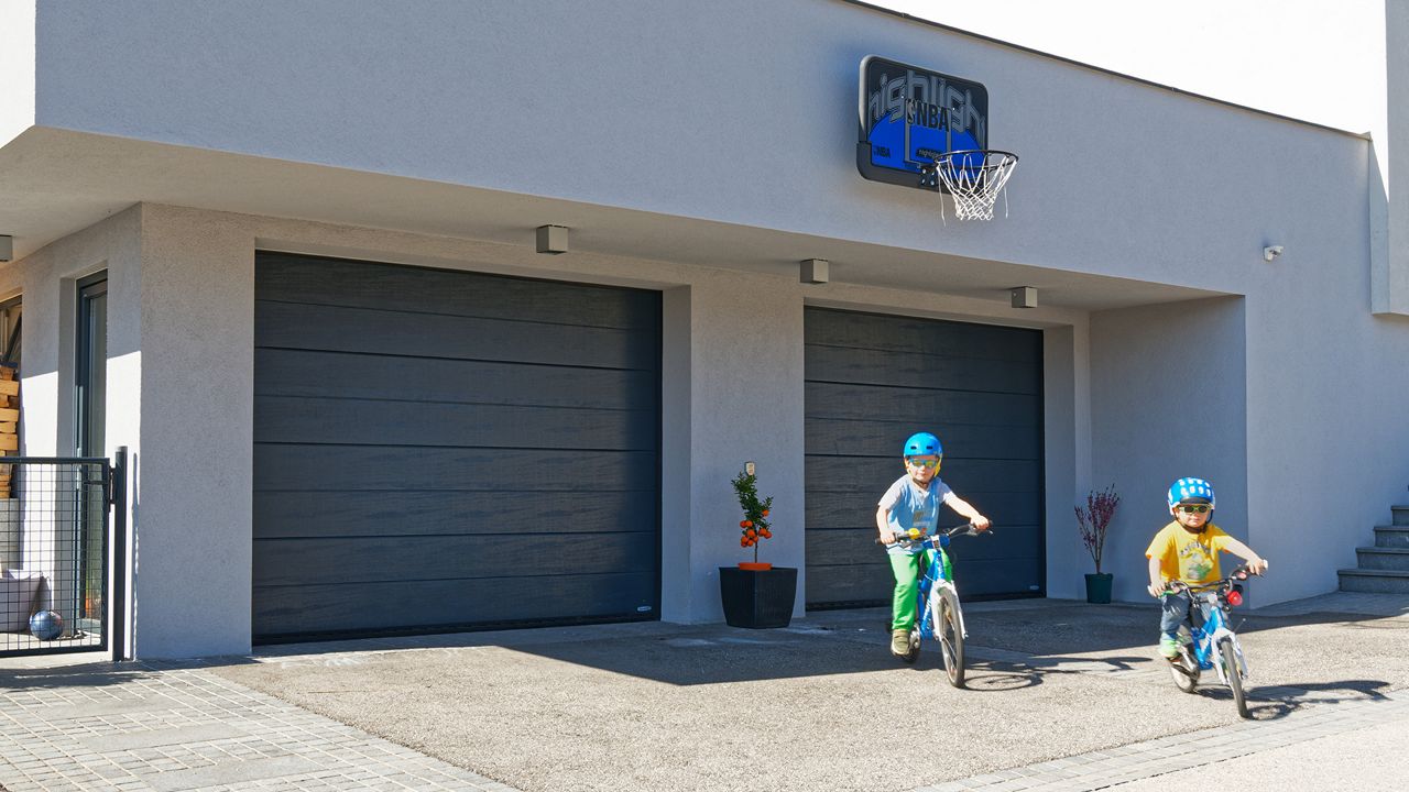 Barn cyklar utanför garaget.