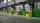 A line of green vertical storing loading docks inside of a warehouse