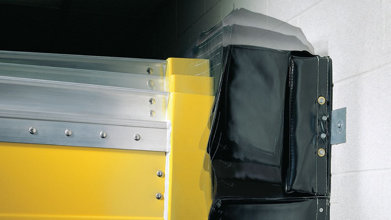 An innovative dock seal system with a two-piece movable head pad that moves vertically to reduce wear and increase lifespan.
