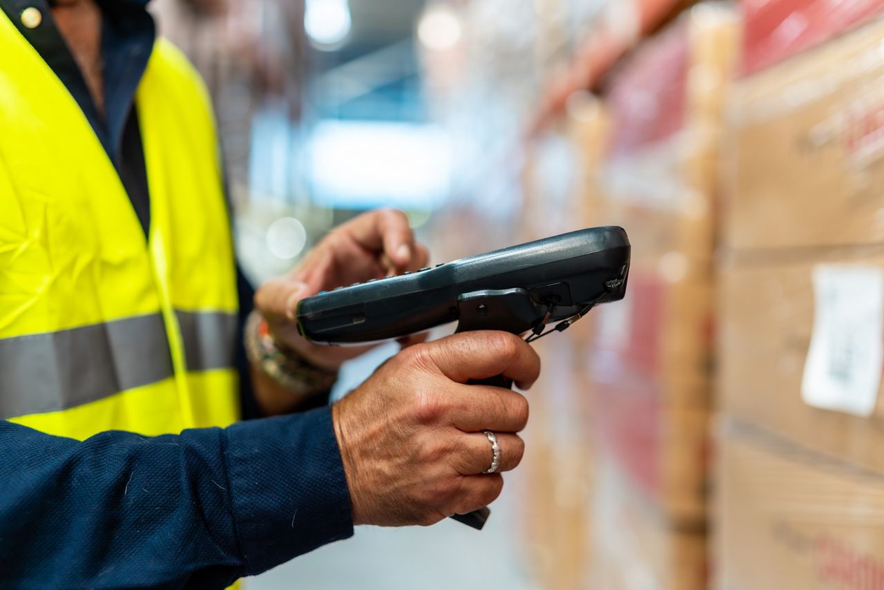 Man using scanner in warehouse
