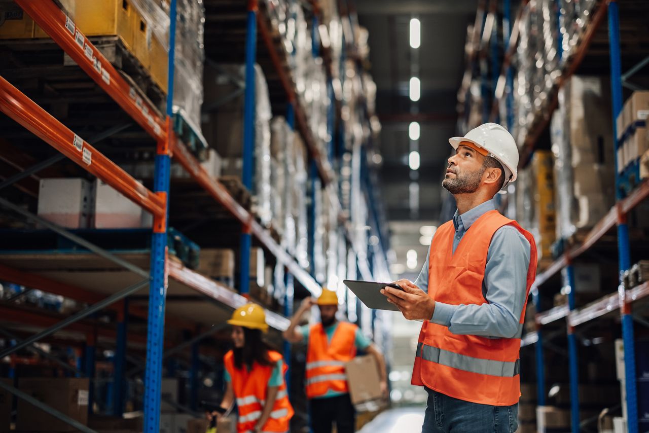 Warehouse worker taking inventory with tablet