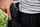Closeup of man holstering a handgun
