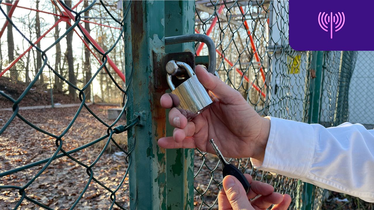 A padlock and hands holding it and a key