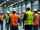 Group of workers having a safety meeting in an industrial warehouse