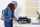 woman is storing away her vauables such as passport and jewlery inside the Yale Smart safe 