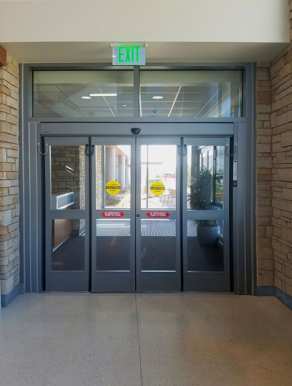 Closed folding doors in a hospital hallway.