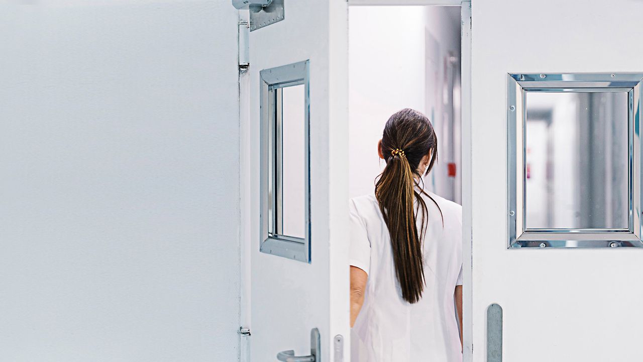 A nurse at a hospital doorway