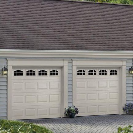Residential house with two ASSA ABLOY white garage doors