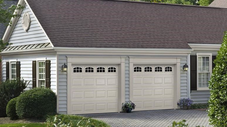 Residential house with two ASSA ABLOY white garage doors