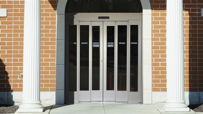 Telescopic sliding door entrance in brick buidling entrance