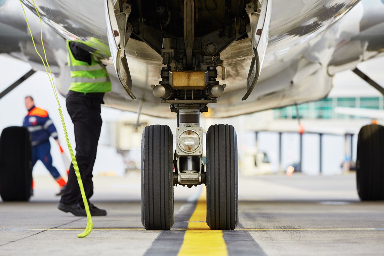 Airport ground crew inspecting plane