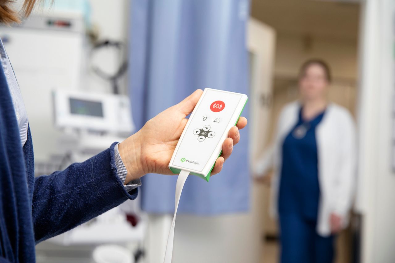 Nurse holding alarm.