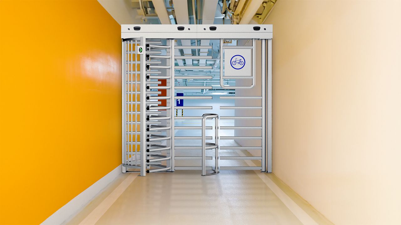 ASSA ABLOY FT600 turnstile gate with dedicated bicycle passageway ensures fast and secure entrance for all visitors. Customisable and weather-resistant.