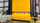 A closed, yellow HS-series door in an industrial facility.