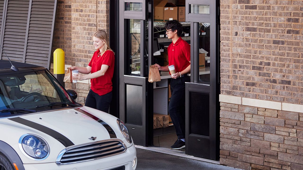 Staff using restaurant doors to deliver food