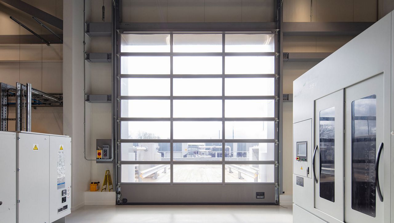An internal image of a ASSA ABLOY OH1042FI glazed insulated overhead sectional door at a UK leading manufacturing company
