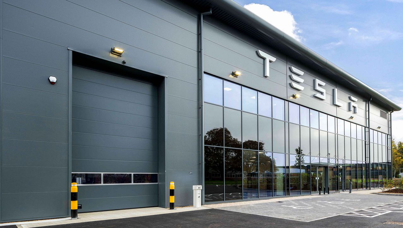 An external image of a Crawford OH1042P overhead sectional door at Tesla Centre Cambridge