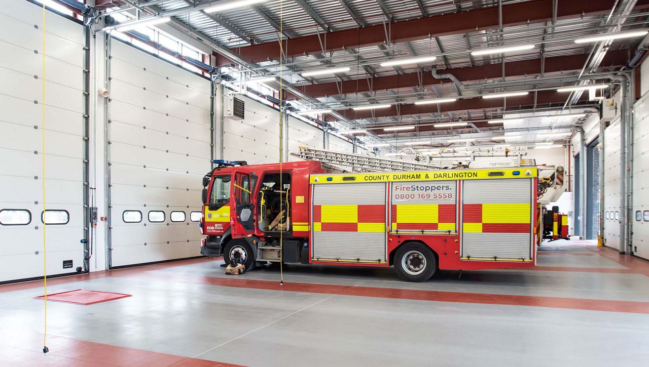 Image: An internal image of a Crawford OH1042P overhead sectional door at a fire station