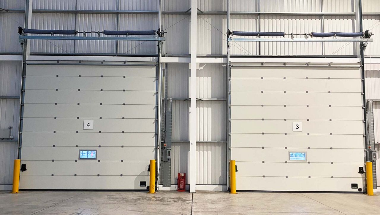 Image: An internal image of a two Crawford OH1042P secured by design overhead sectional door at a Broadheath Network Space, Altrincham