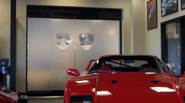 red car infront of assa abloy sliding glazed doors