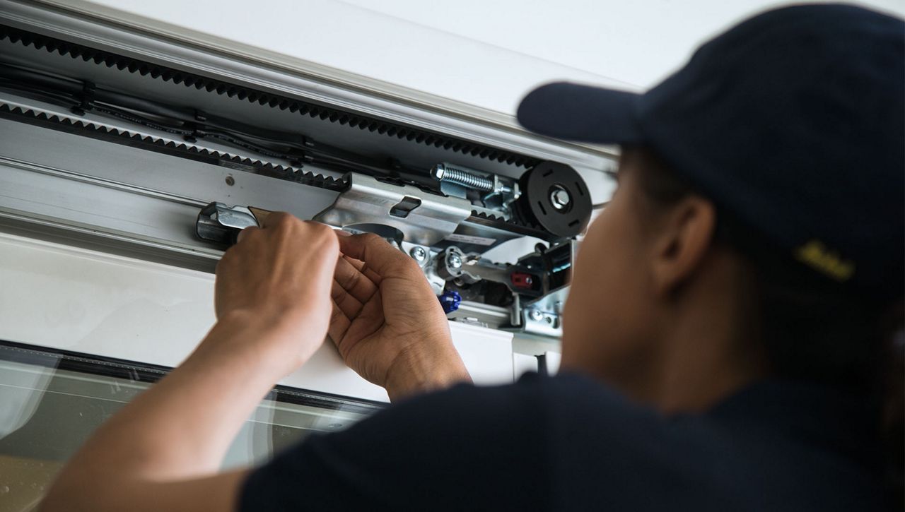 Service engineer repairing a sliding automatic door