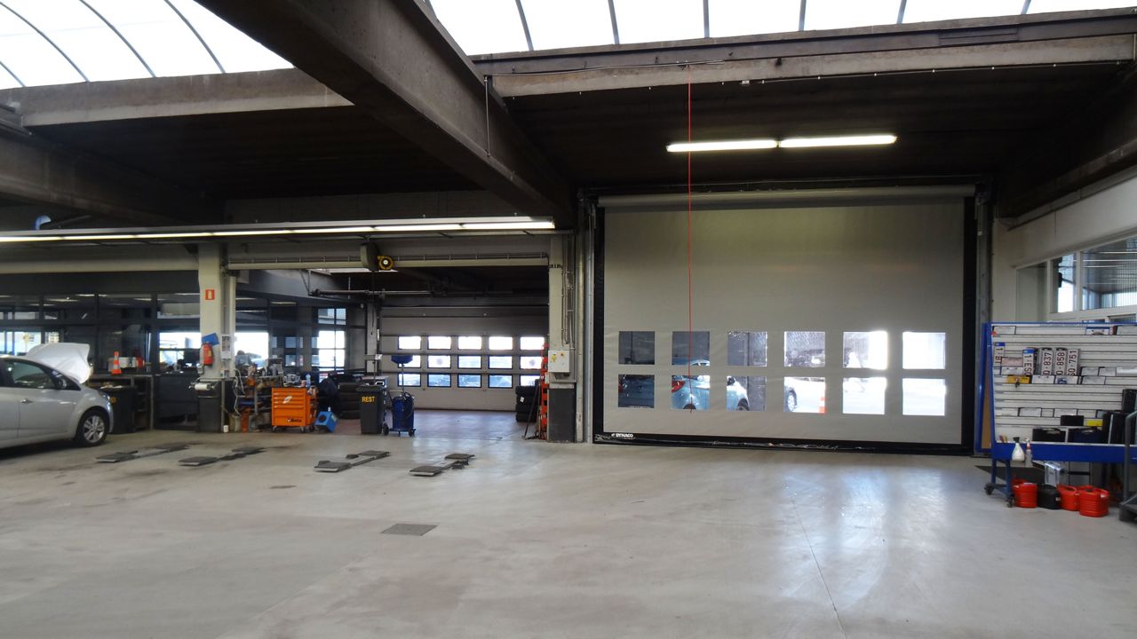 A white high-speed door in a garage.