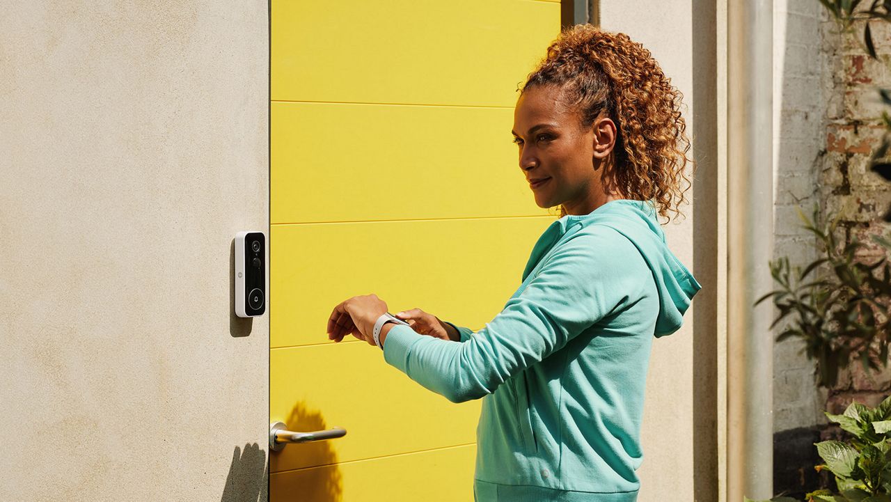 Woman checking Yale Smart Video Doorbell with Smart Watch