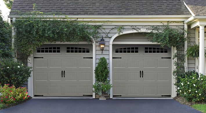 Adding hinges and handles to Heritage Carriage House garage doors completes the look of this traditional design.