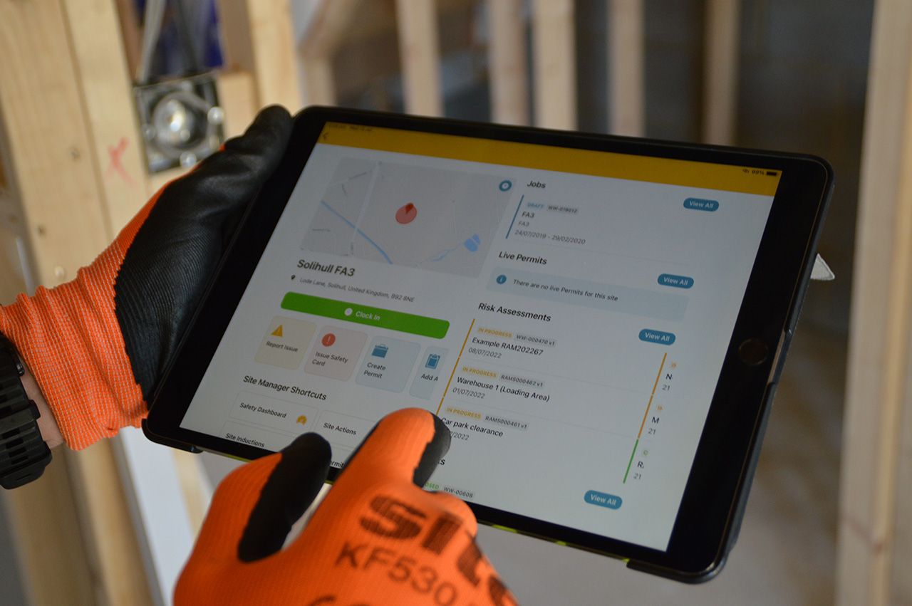 Construction worker holds a tablet device 