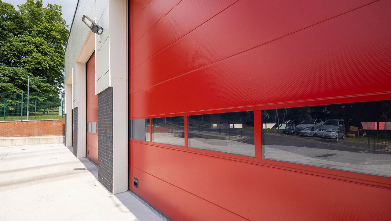 Image: An close up image of a Crawford OH1042S overhead sectional doors at a fire station