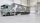 Un camion Lensen portant le numéro 105 et des motifs abstraits se trouve dans un entrepôt spacieux équipé d'une porte roulante ASSA ABLOY.