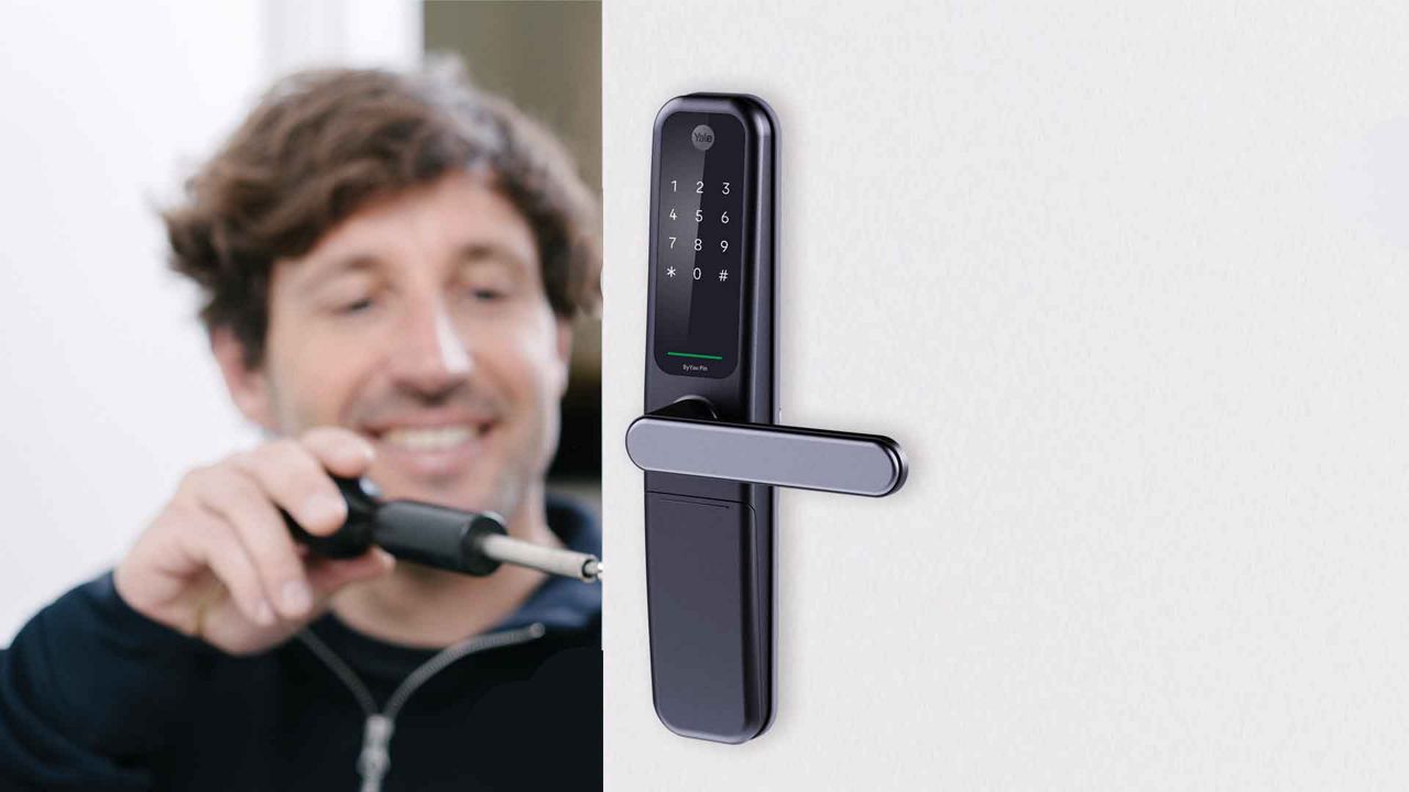 Man installing digital door lock