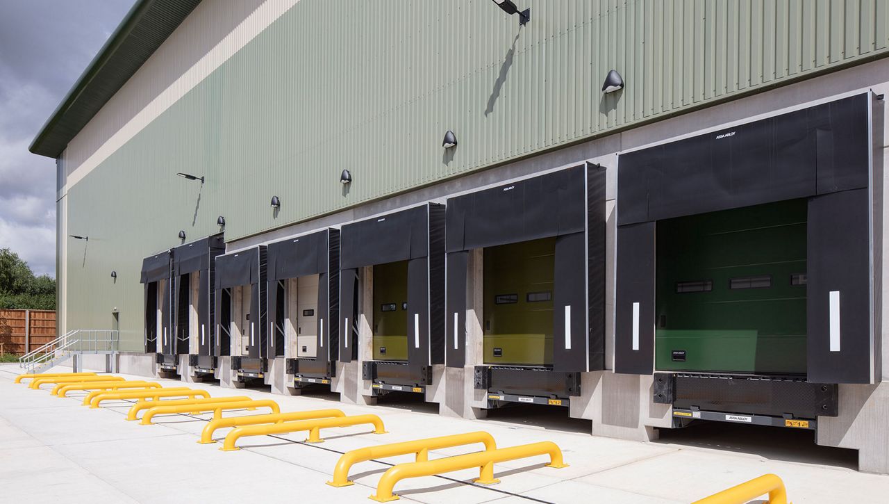 A row of ASSA ABLOY mechanical-curtain dock shelters