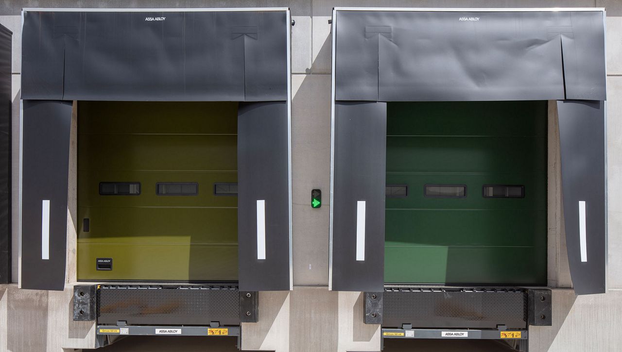 Image: A head on shot of two ASSA ABLOY mechanical-curtain dock shelters